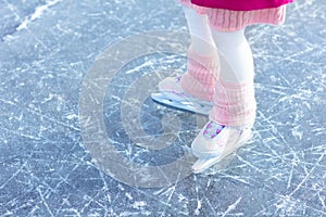 Child skating on natural ice. Kids with skates