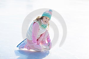 Child skating on natural ice. Kids with skates.