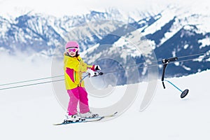 Child on ski lift. Kids skiing
