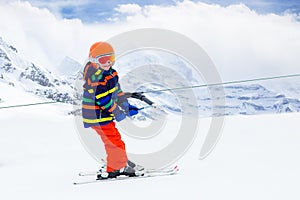 Child on ski lift. Kids skiing