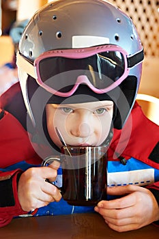 Child skier drinking tea