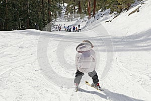Child skiing downhill