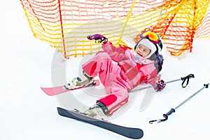 Child skiing in mountains. Active toddler kid with safety helmet, goggles. Winter sport for family.