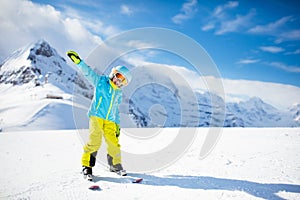 Child skiing in the mountains. Kid in ski school. Winter sport for kids. Family Christmas vacation in the Alps. Children learn