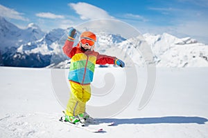 Child skiing in the mountains. Kid in ski school. Winter sport for kids. Family Christmas vacation in the Alps. Children learn