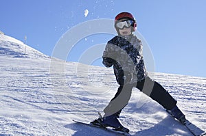 Child skiing and throwing snowball