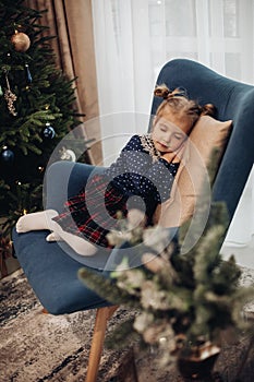 Child sleeping in armchair.