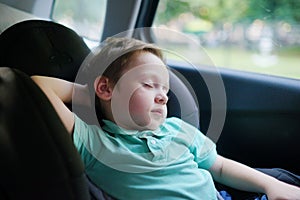 Child sleeping in a car. Baby savety chair. Transportation background. Travelling with family.