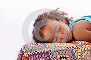 Child, sleeping and relax on bed in home, dreaming and wellness on quilt blanket for childhood development. Girl, tired