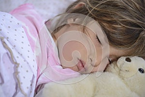 Child sleeping with teddy bear