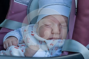 The child sleeps comfortably and safely in the car`s child restraint