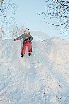 Child slides down a snowy hill