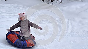 Child slides on snow tubing