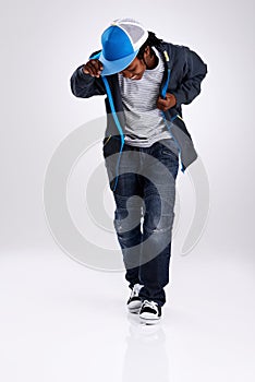 Child, smile and dancing with hiphop and street style clothing in a studio with boy dancer. Trendy, energy and cool