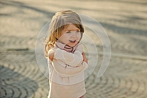 Child smile with hug hand gesture on sunny day