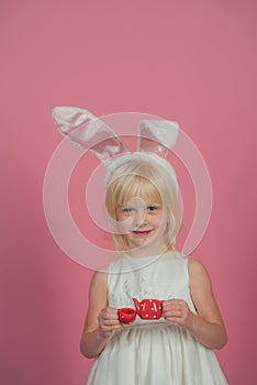 Child smile with toy tea pot and cup