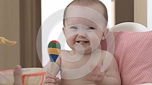 A child smiles and eats porridge