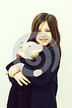 Child or smiling cute girl hugging cute, teddy bear toy