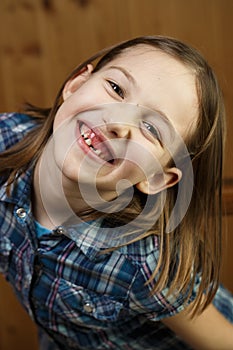 Child smiling, showing her missing milk teeth