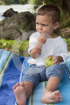 Child snacking fruit in nature