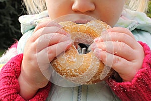 Child snacking on unhealthy chocolate donut