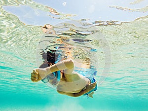 Child snorkeling in clear water