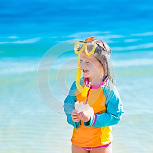 Child snorkeling on tropical beach