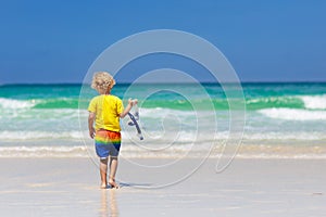 Child snorkeling on tropical beach. Kids snorkel