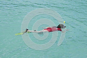Child snorkelling in the blue laggon photo