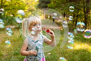 Child and soap bubbles in summer