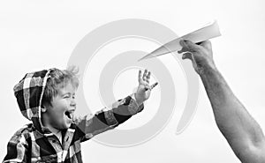 Child son playing with paper airplane. Carefree. Freedom to Dream - Joyful Boy Playing With Paper Airplane. Dream of