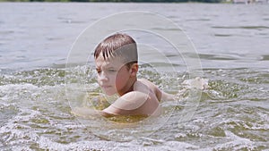 Child Splashes in the Water, the River, Creating Waves, Splashes, Whirlpools. 4K