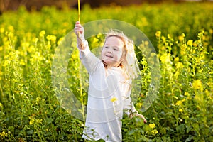 Child in spring park with flowers