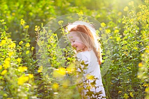 Child in spring park with flowers