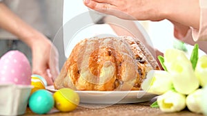 Child sprinkles flour powdered sugar on cake