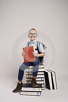 Child among a stack of books