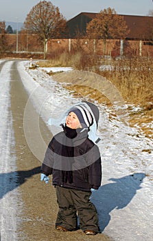 Child stand on the road.