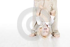 Child standing head over heels.