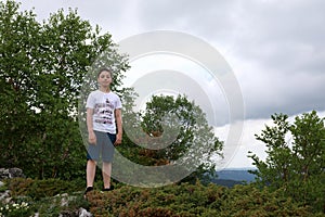 Child standing on rock on Lago-Naki plateau in summer
