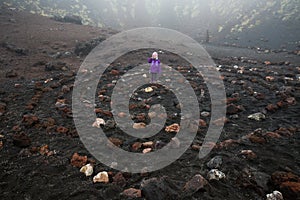 Child standing in spiritual spiral in Etna volcano crater