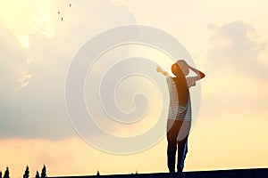 The child stands pointing forward glad the sky background