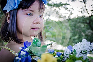 Child stearing with flowers