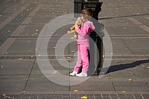 Child and street lamp post