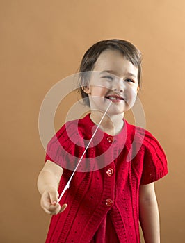 Child stretching a chewing gum from her mouth