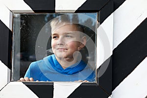 Child in striped black and white guard booth