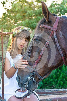 Child stroking her horse