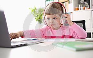 Child study at home with laptop and headphones