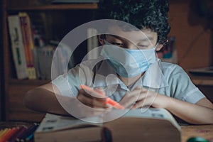 Child studying a book in the 2020 classes in the middle of the covid-19 photo