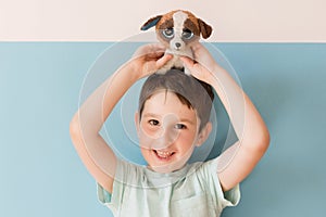 Child with stuffed toy blue background