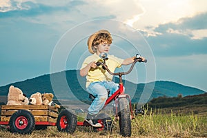 Child Success, leader and winner concept. Faith and trust. Freedom and happiness kids concept. Kid on bike Enjoyment